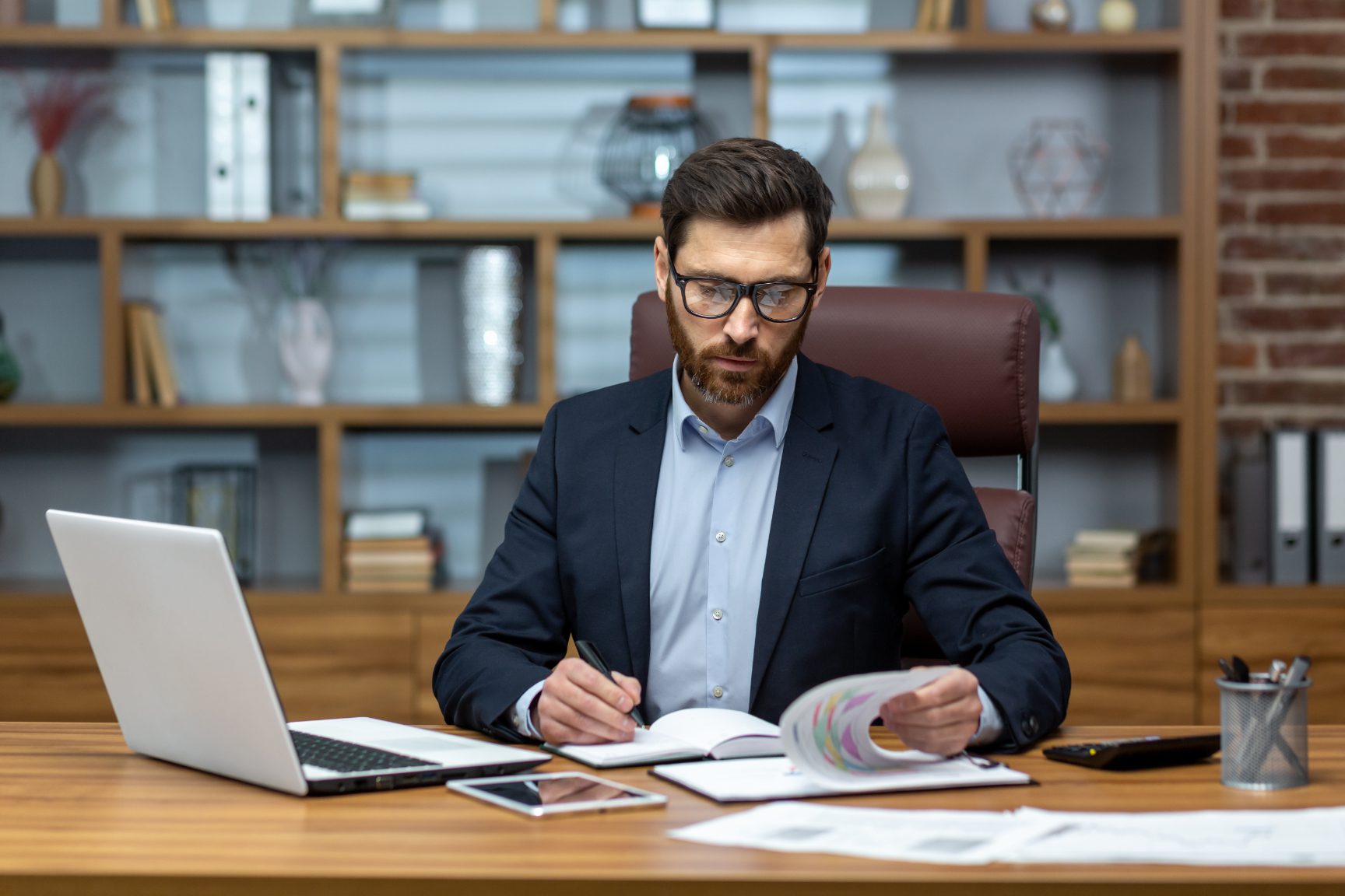 Man working at desk with documents.