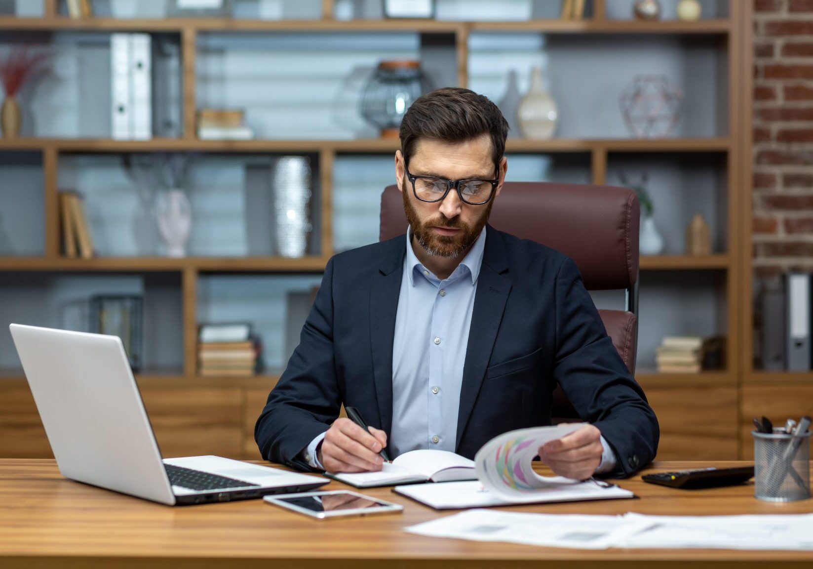 Man working at desk with documents.